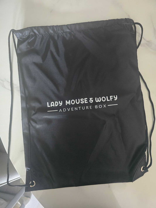 Black branded drawstring bag with Lady Mouse & Wolfy Adventure Box logo, ideal for PE kit.